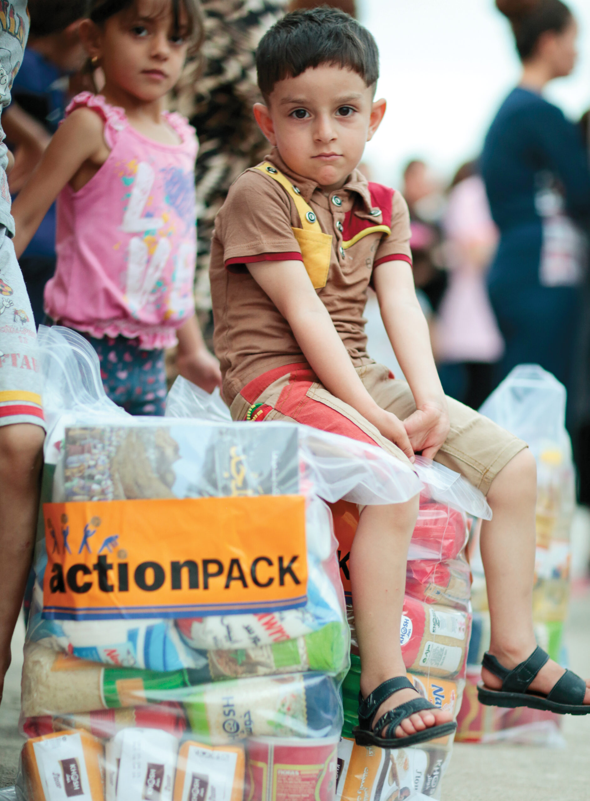 a child sits on an action pack provided by VOM