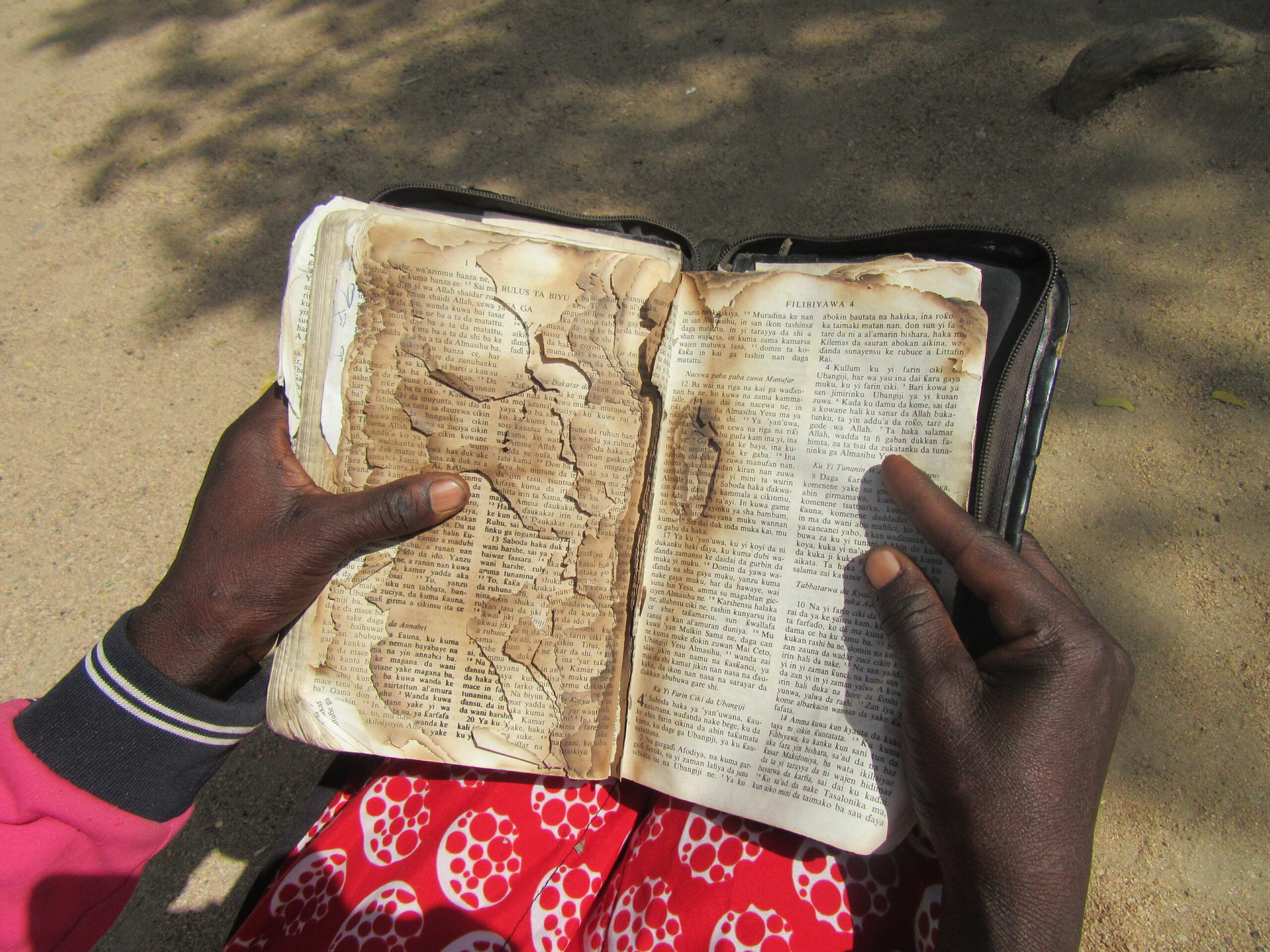 Nigerian girl reads a burned bible