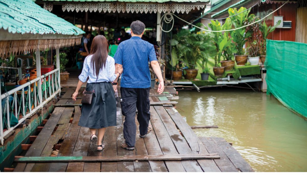 Husband and Wife walking up a ramp to get onto a boat