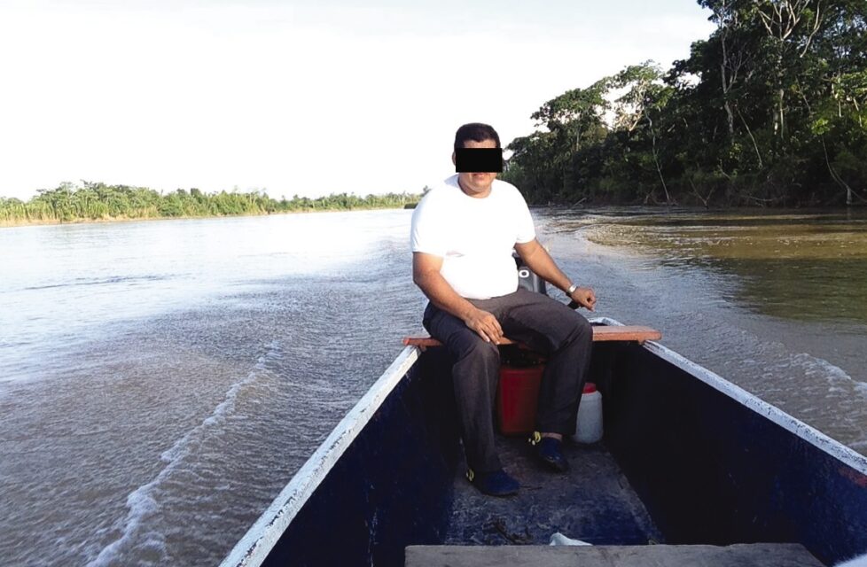 a an sits at the front of a small boat