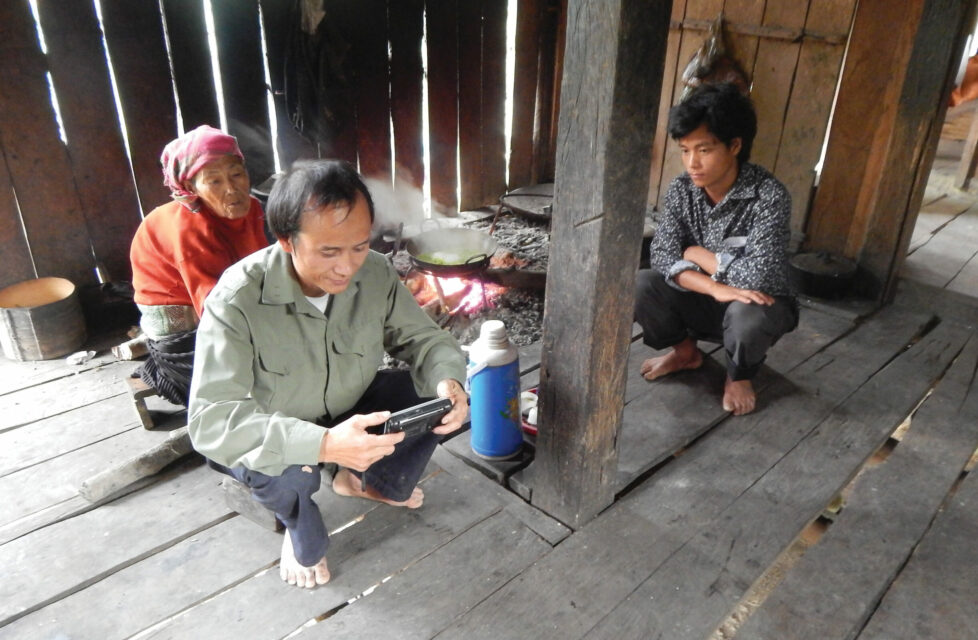 A family of three sit in their home reading