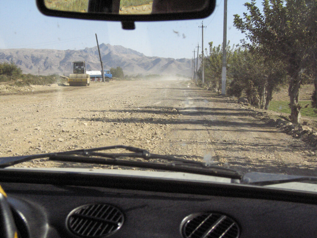 Car driving on dirt road in foreign country
