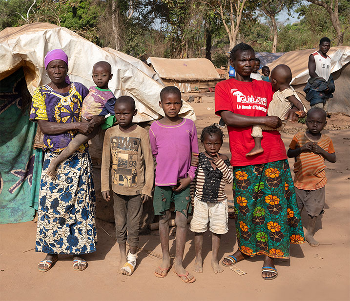 Family standing outside house