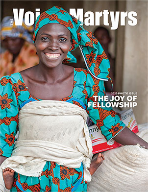 Magazine cover showing smiling woman with bag of rice