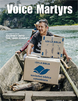 Magazine cover showing men in canoe with boxes of Bibles