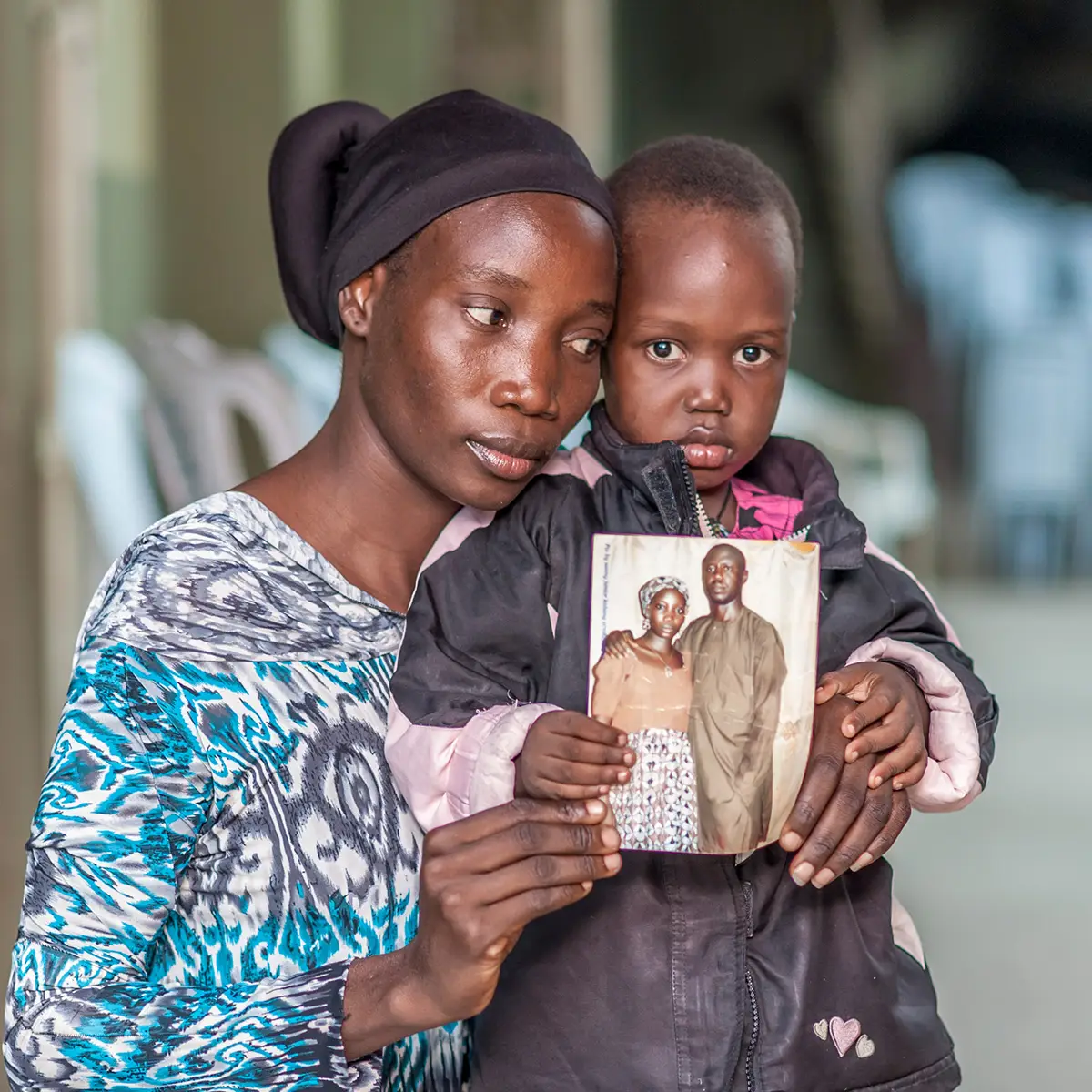 Woman and child holding up photo