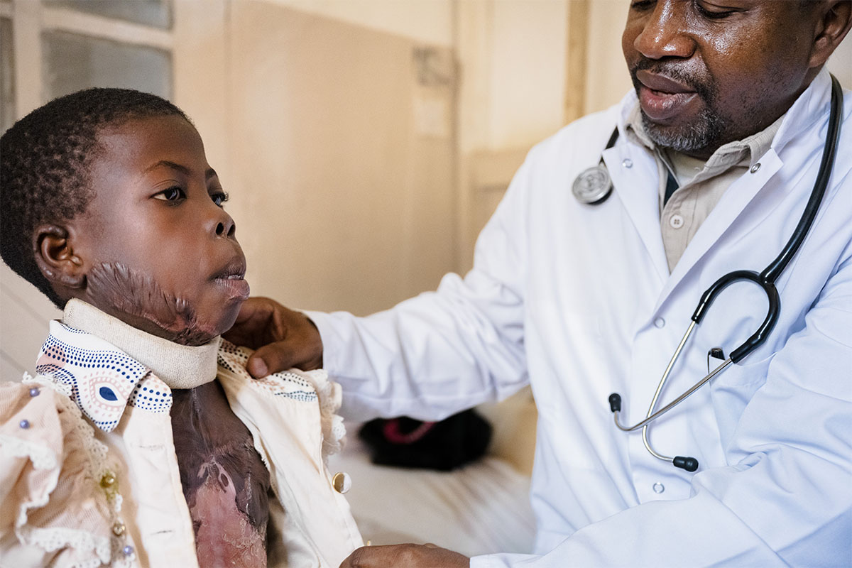 Doctor with child who has burn wounds