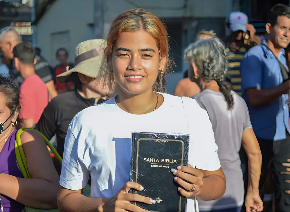 Teenager holding up a Bible