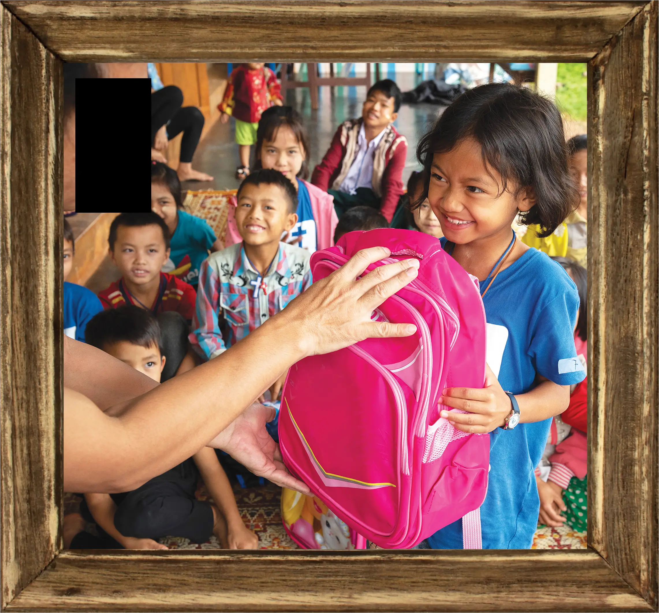 Girl being handed a Christmas Care Pack