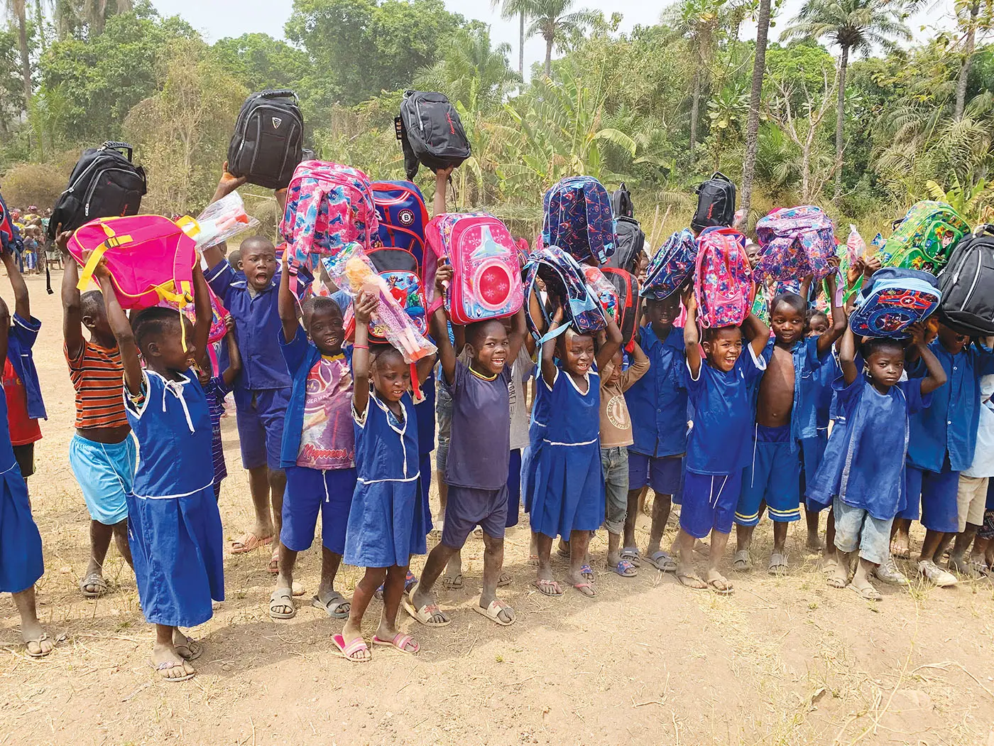 Group of kids holding backpacks up