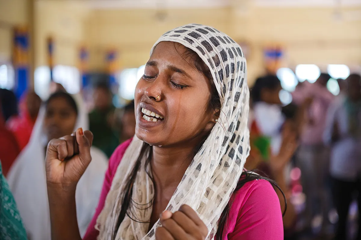 Woman with her eyes closed in prayer