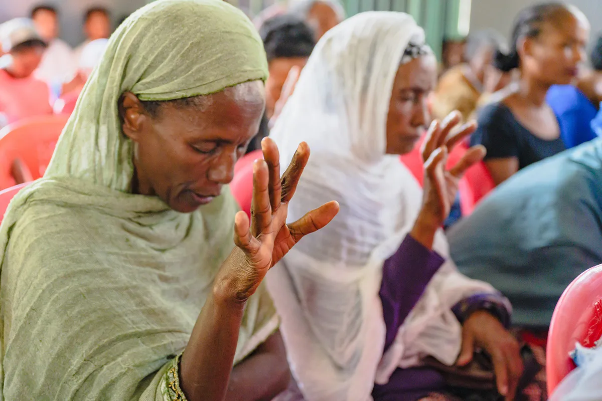 People praying in church service