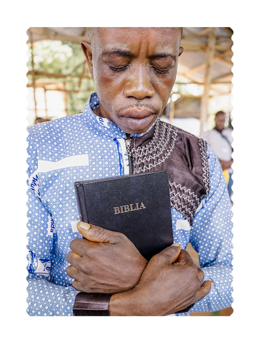 Man crying holding a Bible
