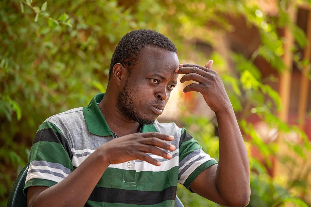 Man gesturing to his forehead