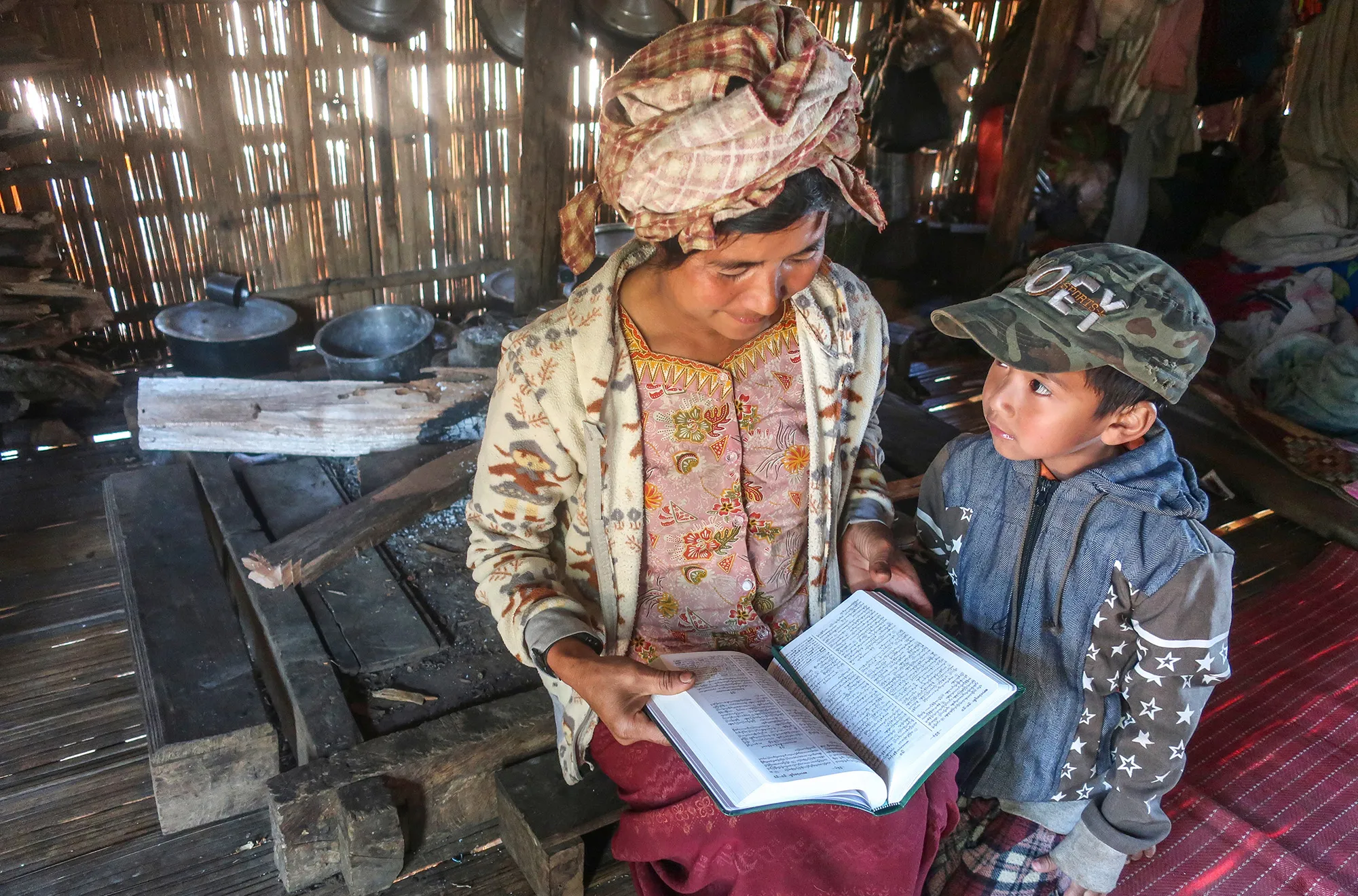 Woman reading a Bible to a child