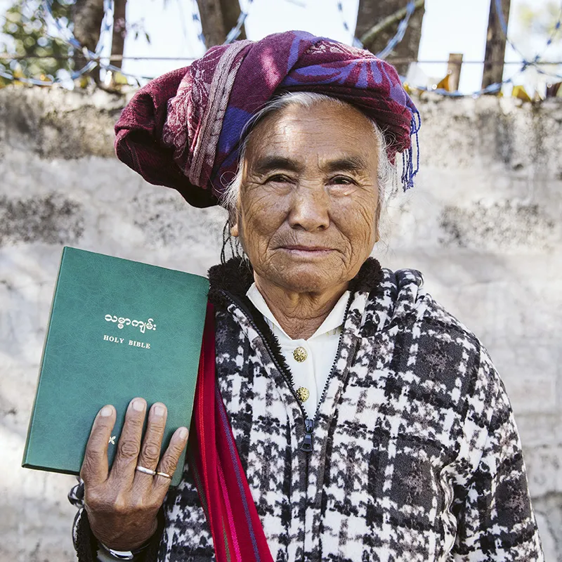 Older man holding a Bible