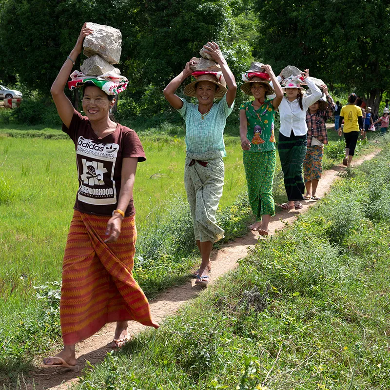 Group of people walking down a dirt path