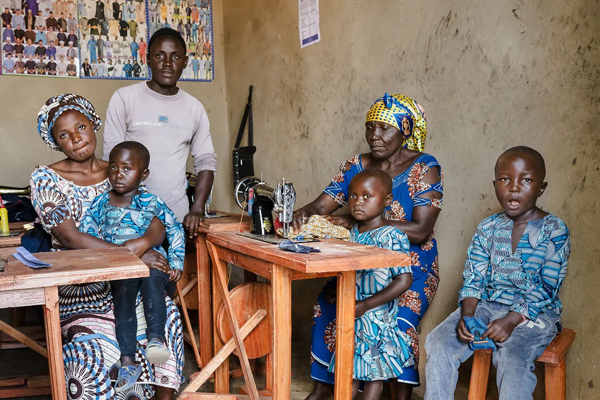 Juliet (on left with child in lap) is now raising her sister’s three orphaned children.