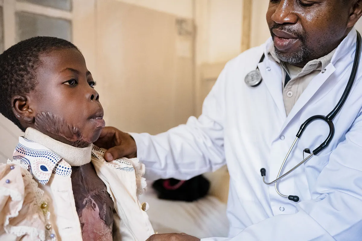 Doctor helping child patient