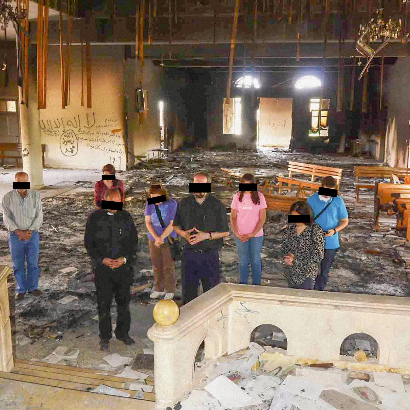 Group of people inside remains of a church