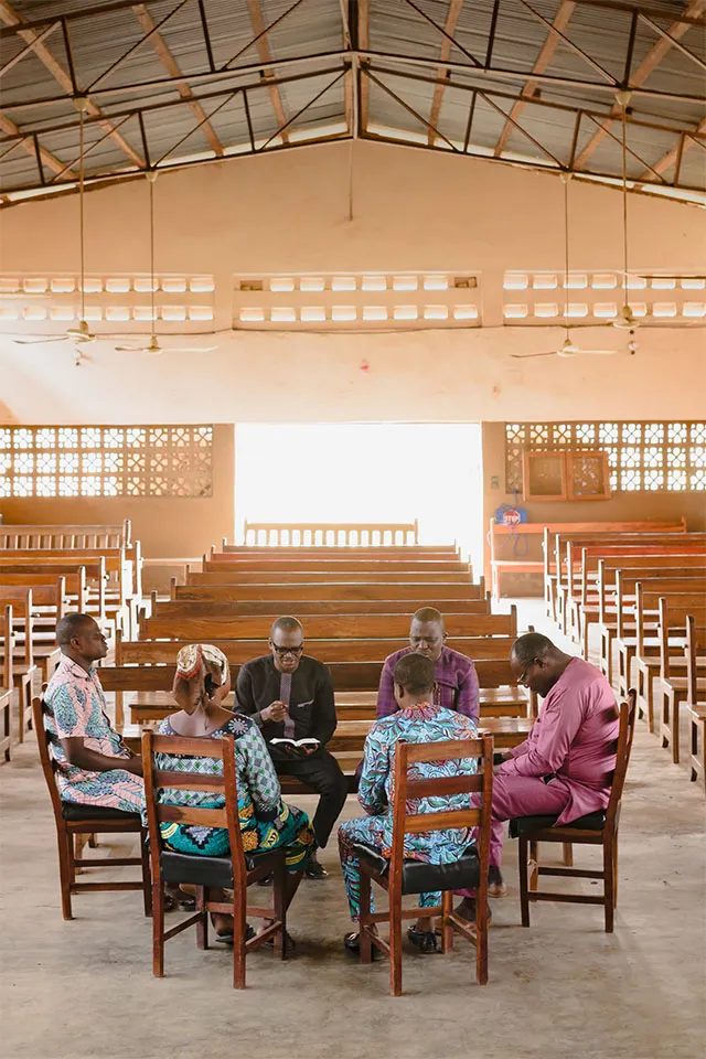 Group sitting in a circle of chairs in a church