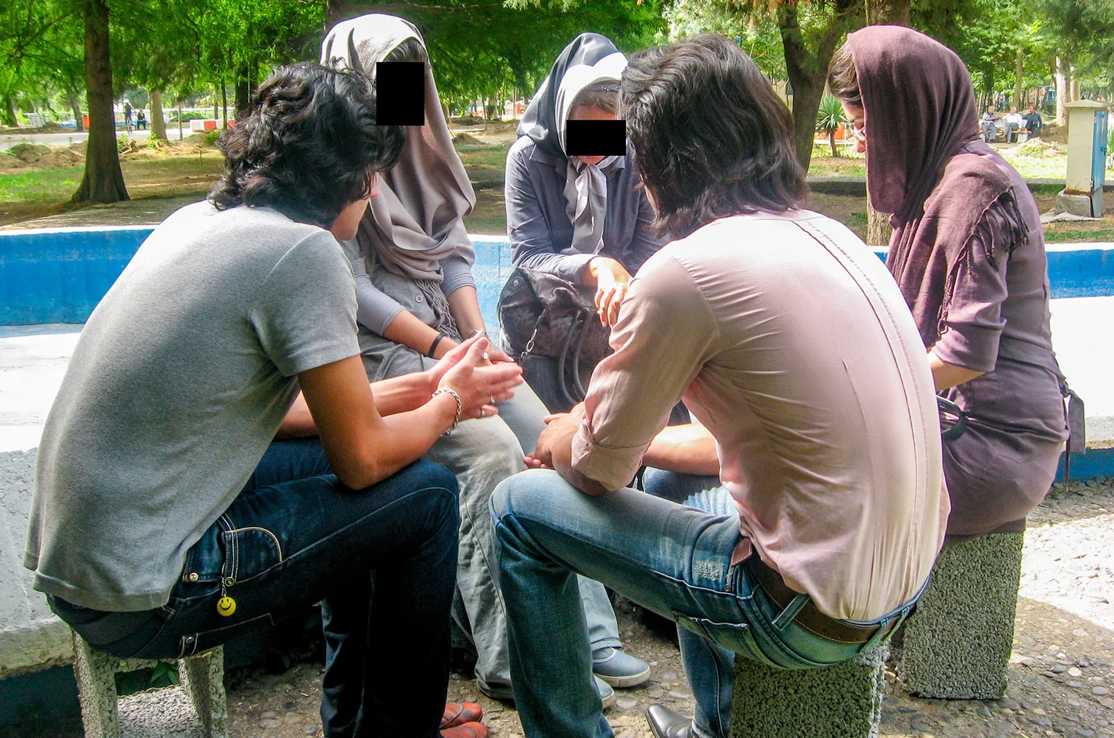 Group sitting outside praying