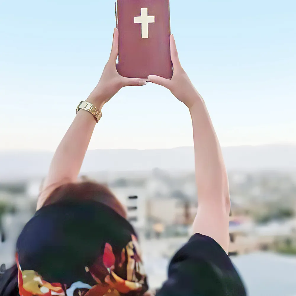 Person holding up a Bible