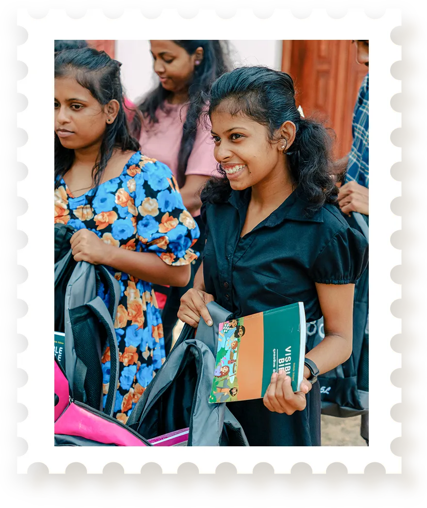Girl opening backpack and pulling out Bible