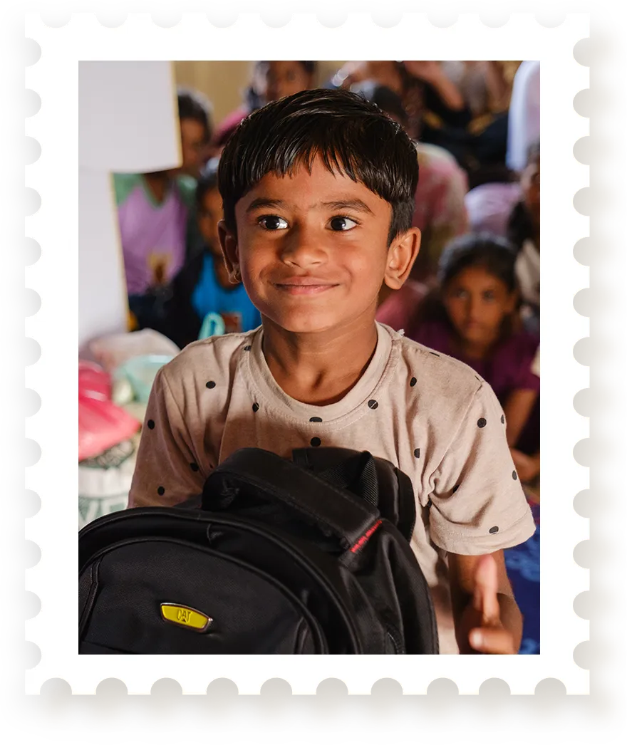 Boy holding backpack