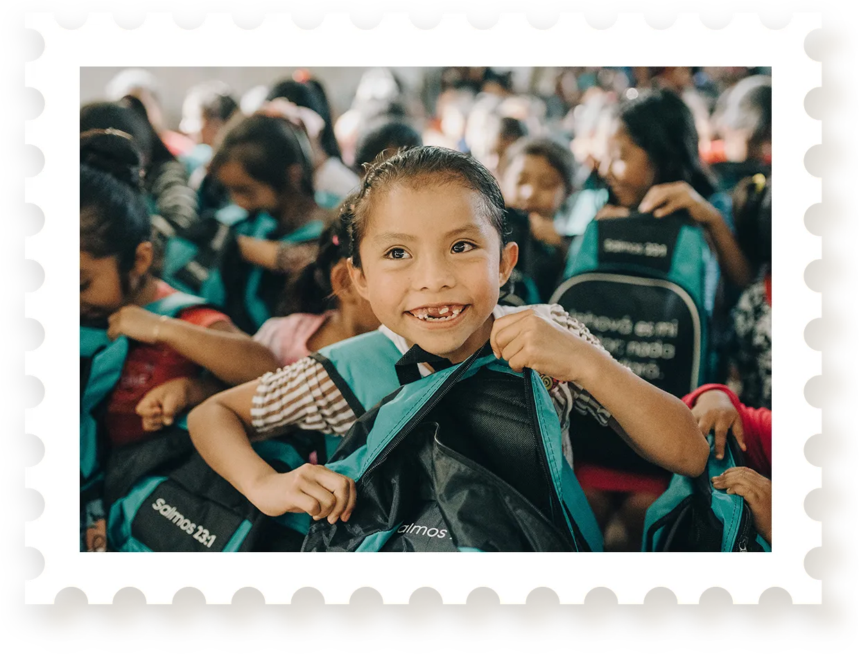 Crowd of kids holding backpacks up