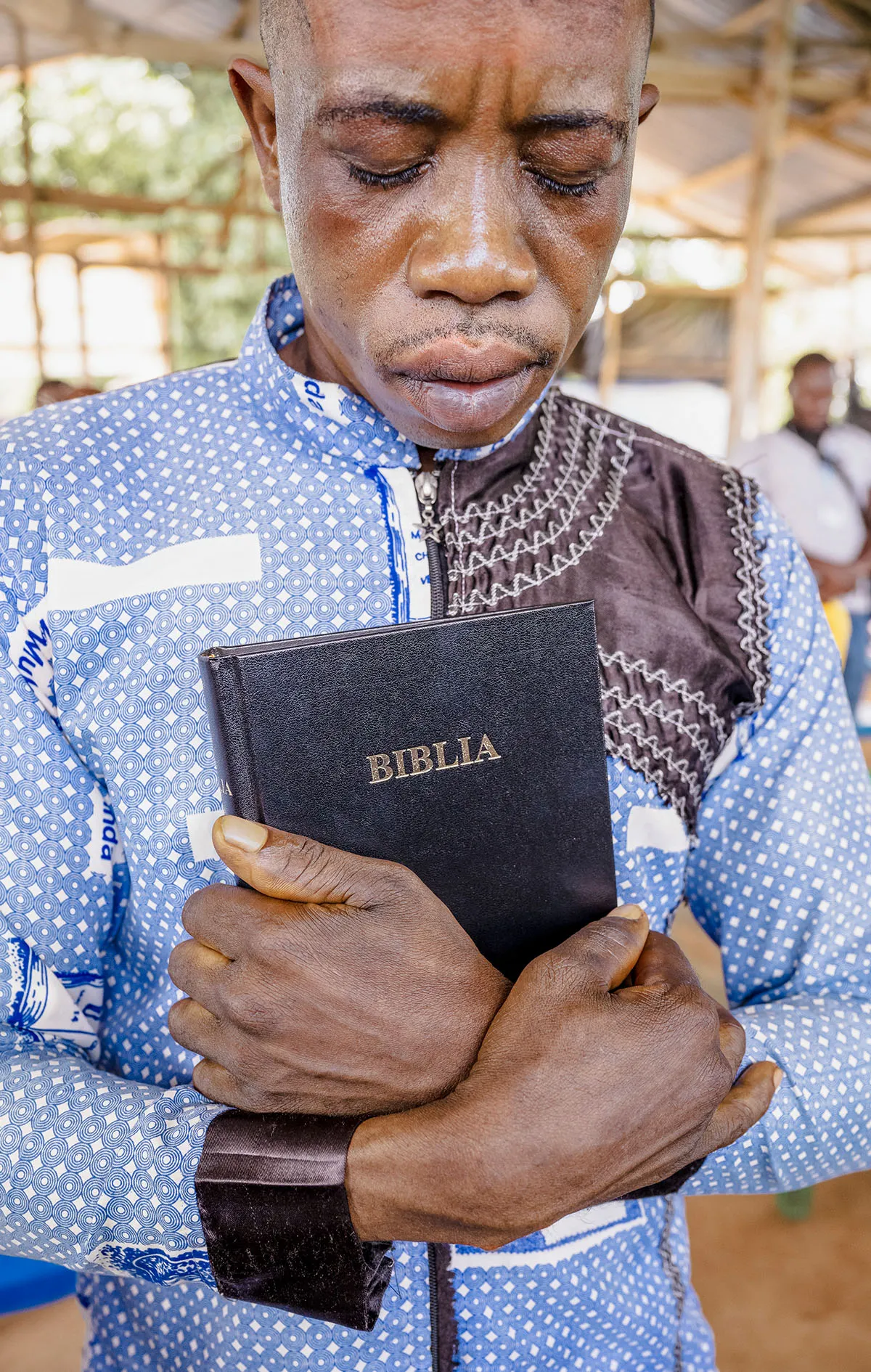 Man crying with Bible