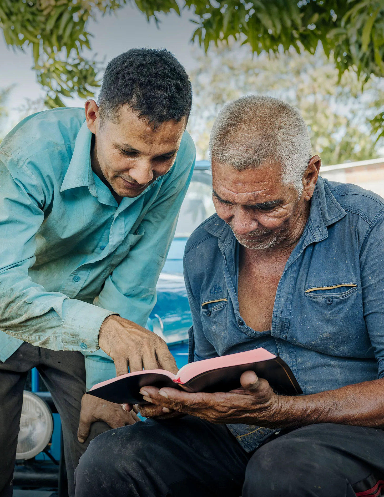 Two men reading Bible together