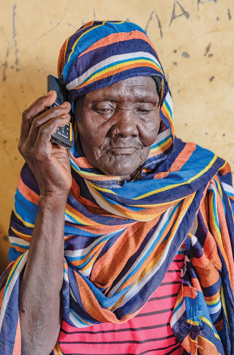 Older woman listening to Bible on audio device