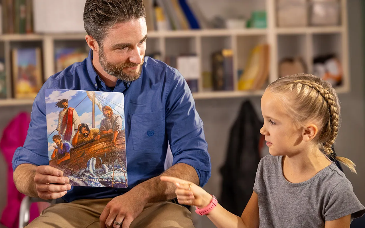Man reading resource to kids