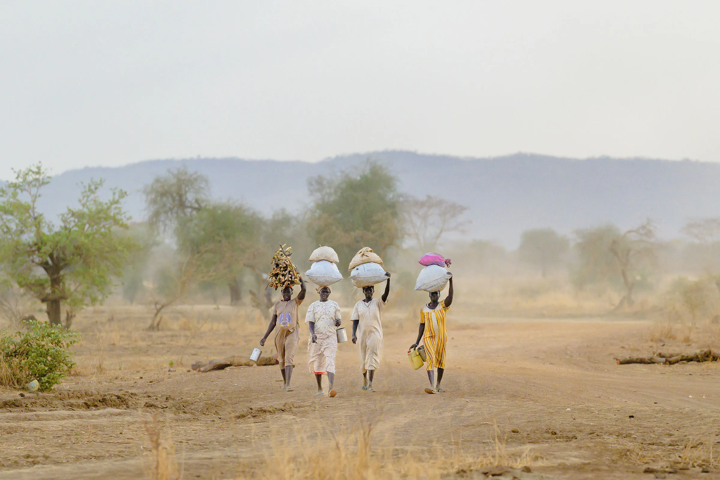 Group of women carrying supplies