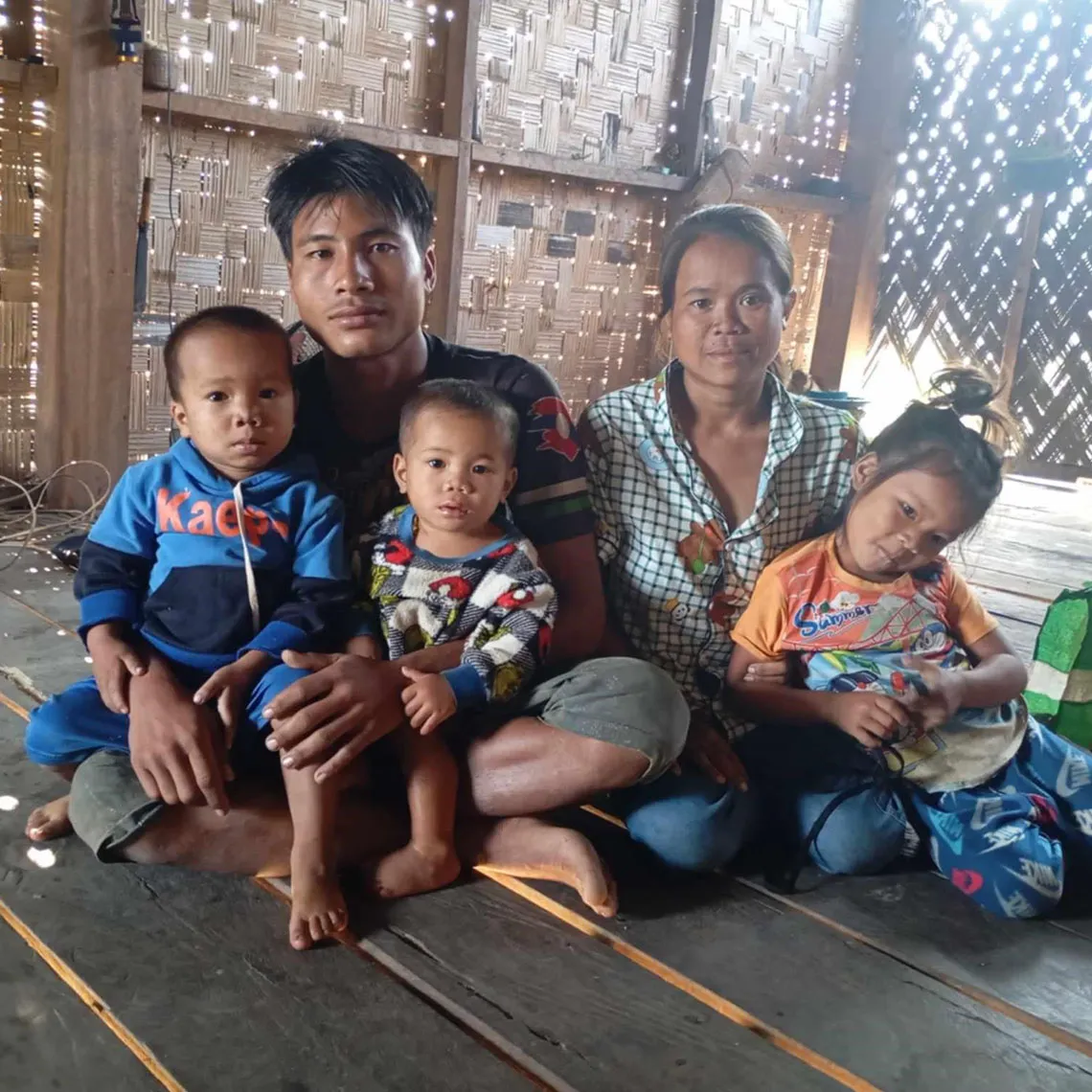 Family sitting on floor with supplies