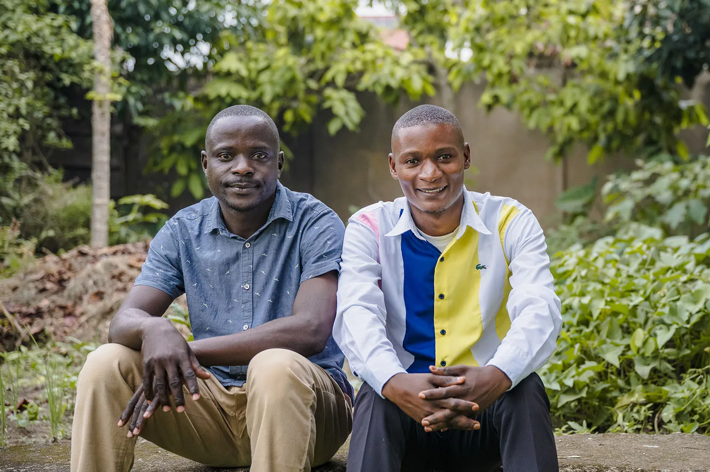 Two men sitting and smiling