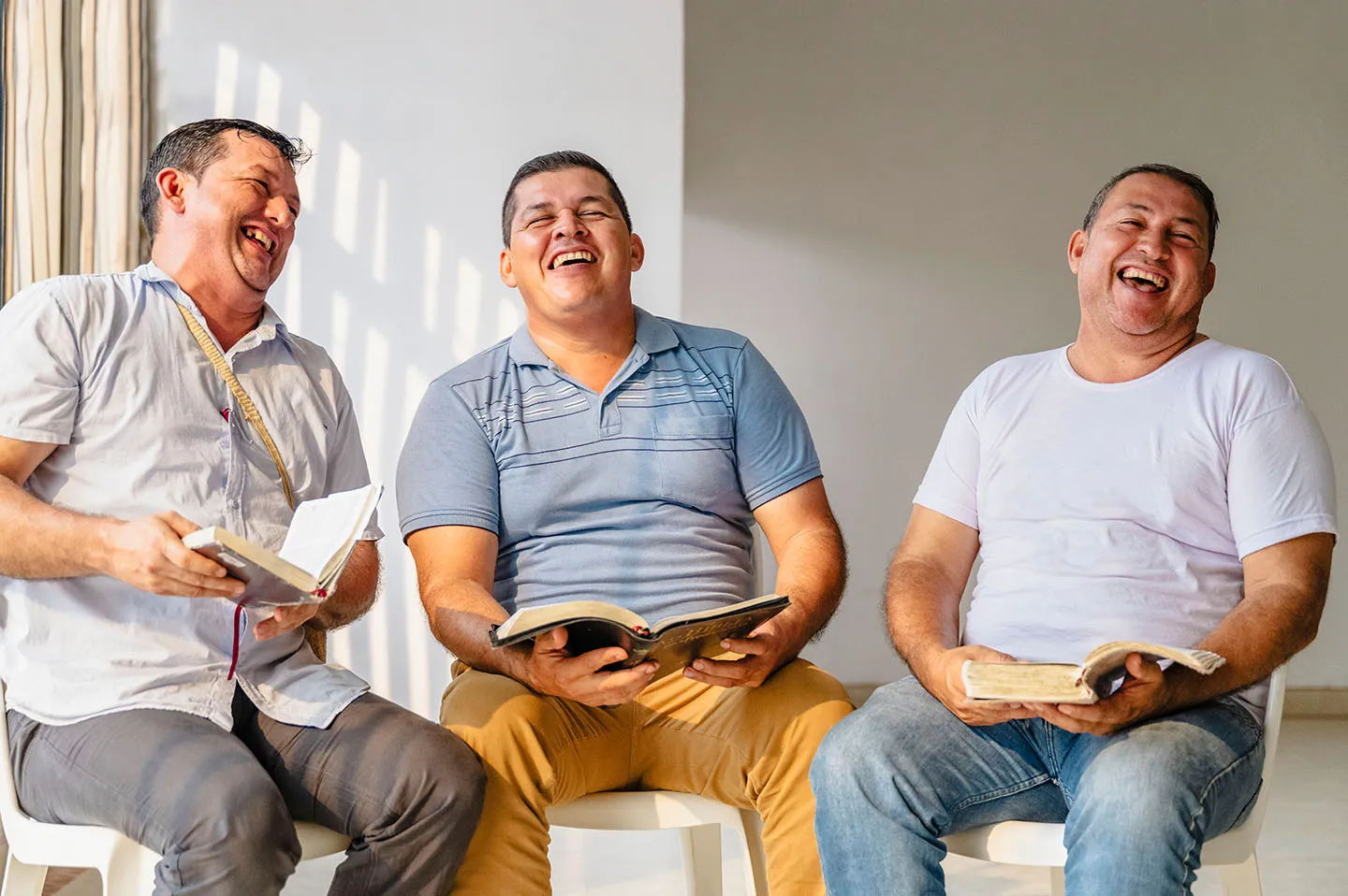Three men laughing together