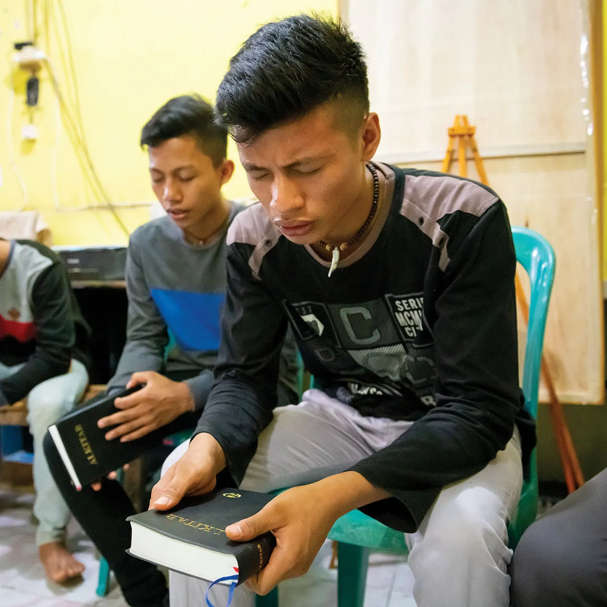 Group of young men praying