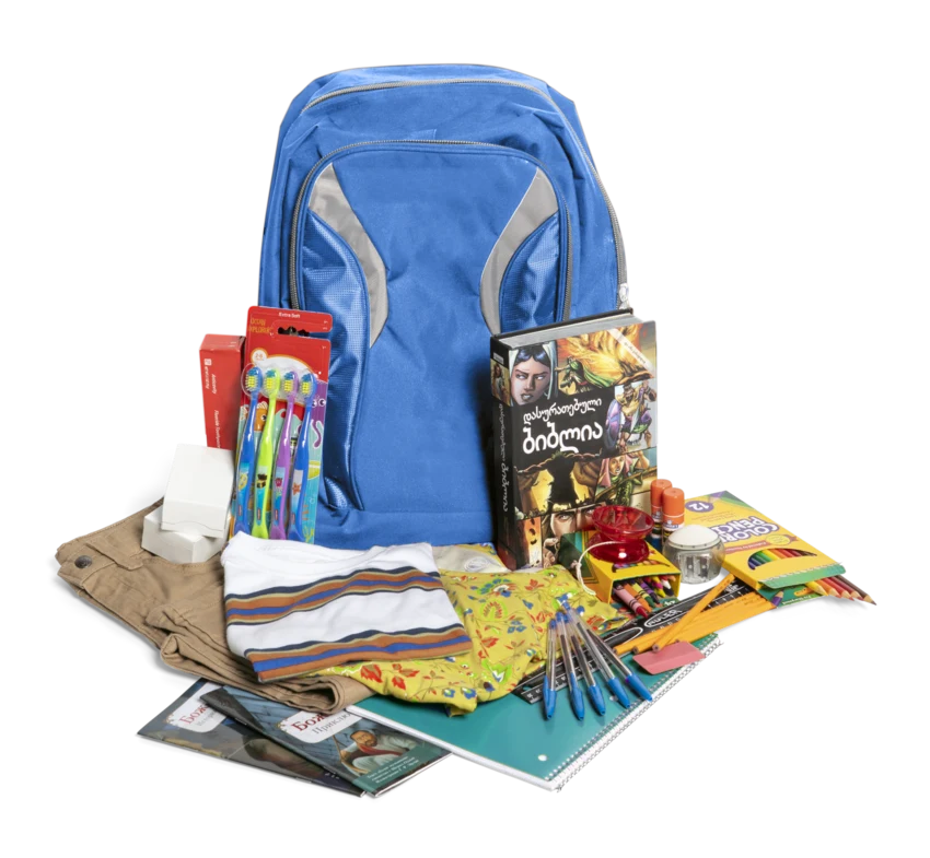 A Christmas Care Pack with a backpack, Bible, school supplies, clothing and other gifts