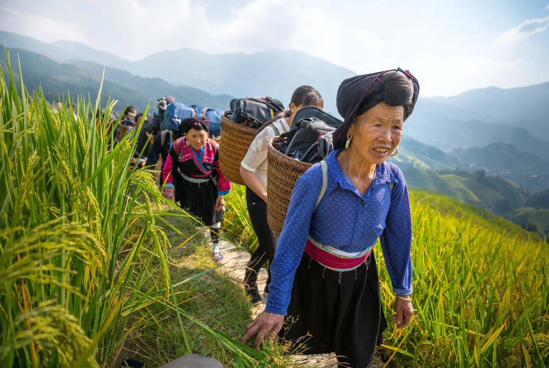 Women walking through hillside fields