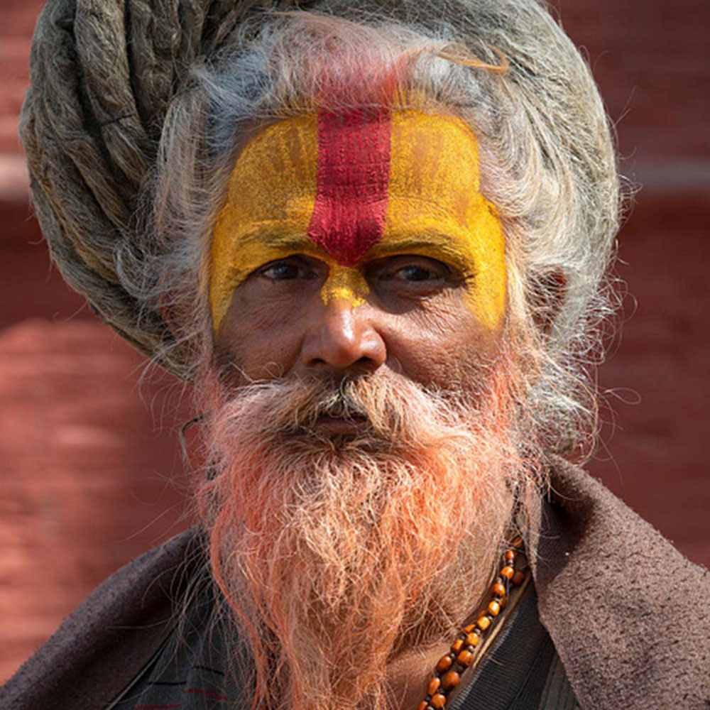 Man with yellow and red paint on his face