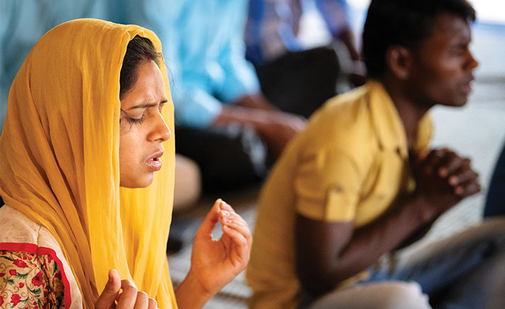 Una mujer ora en la India.