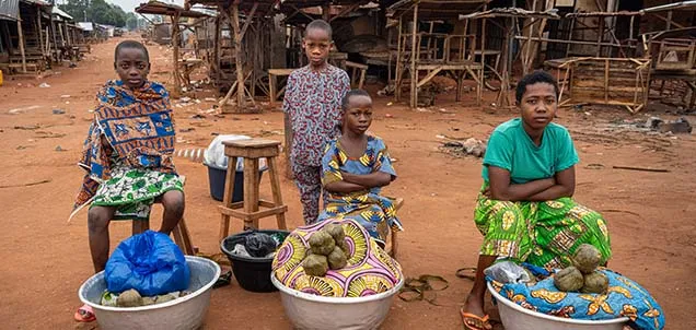 Kids in front of tubs of clothes