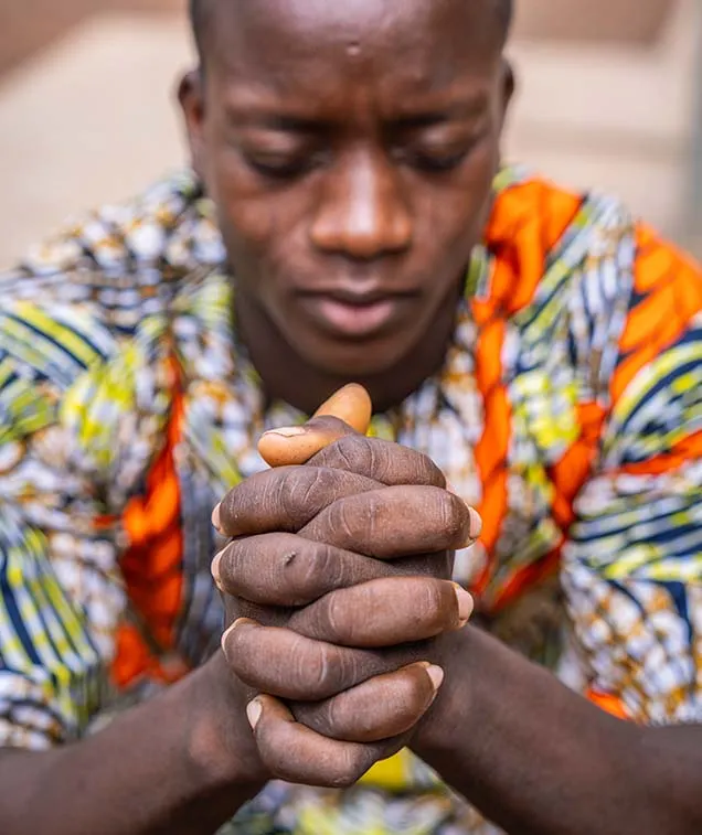 Man hold hands in front of him praying