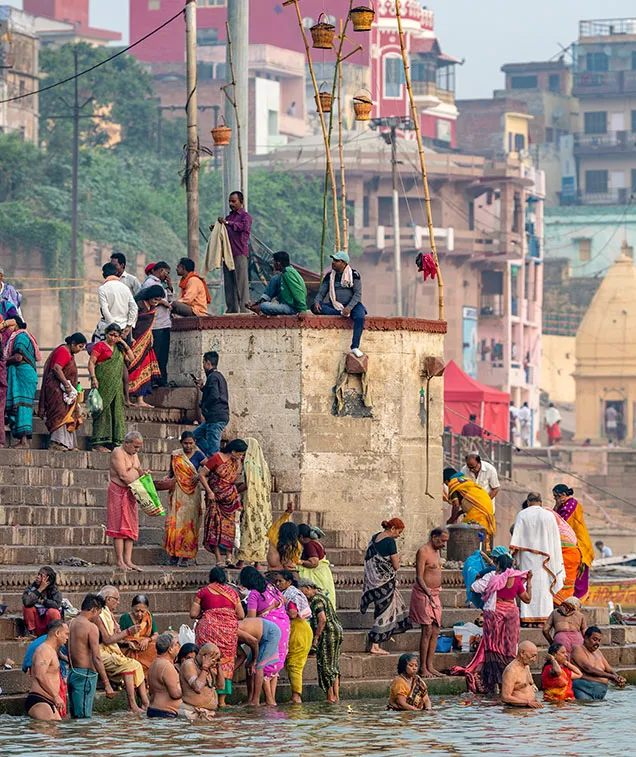 Group of people sitting on side of river