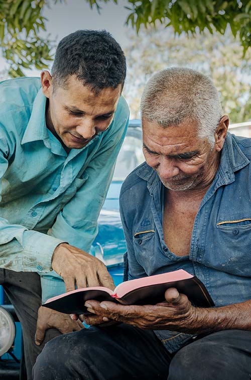 Men reading a Bible together