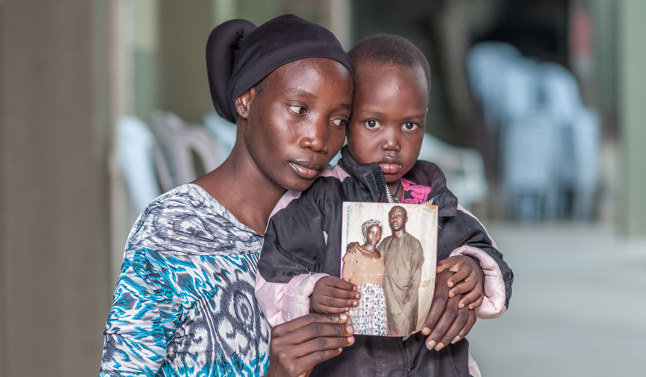 Mom with child holding image of martyred father