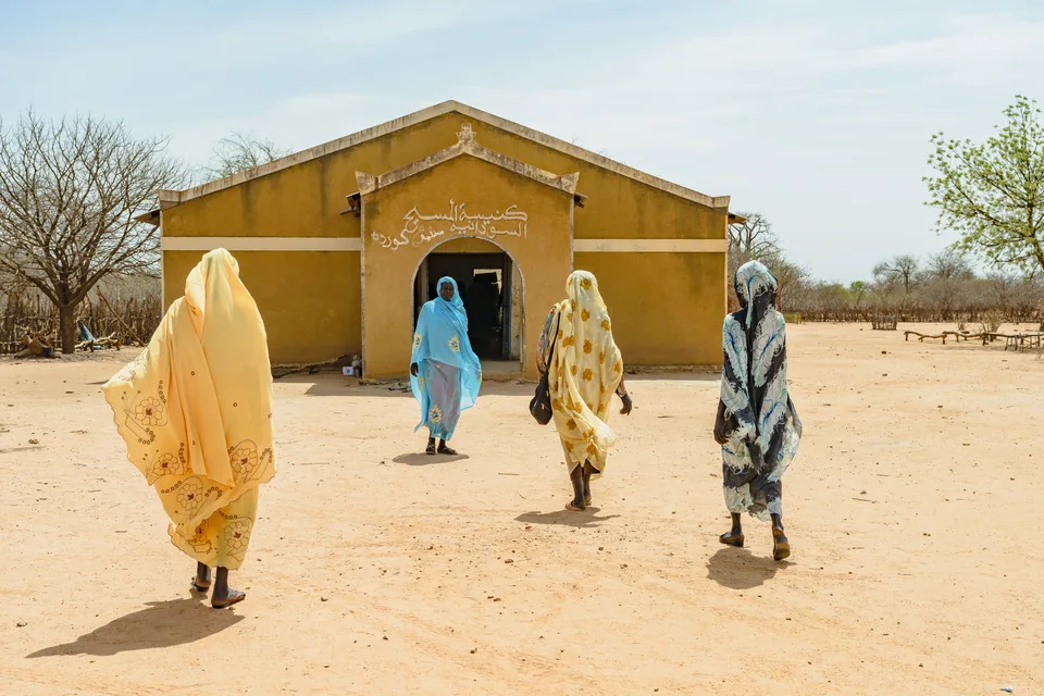 Women gathering outside a church in Sudan