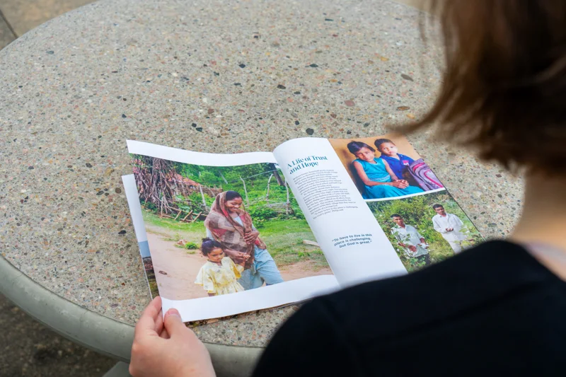 A reader exploring a VOM magazine story featuring a mother and her children